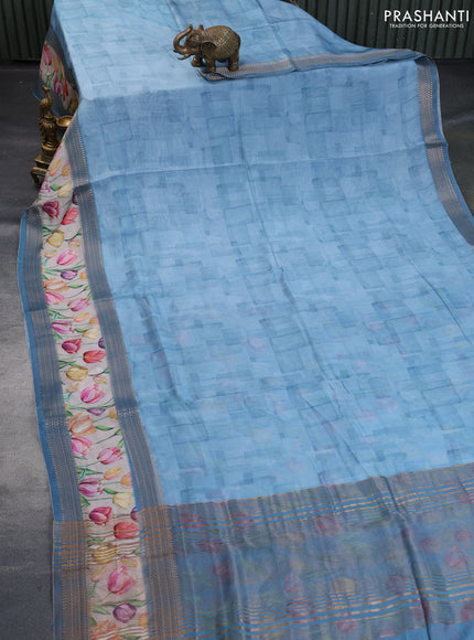 Muslin silk saree light blue shade and cream with allover prints and rettapet zari woven floral printed border