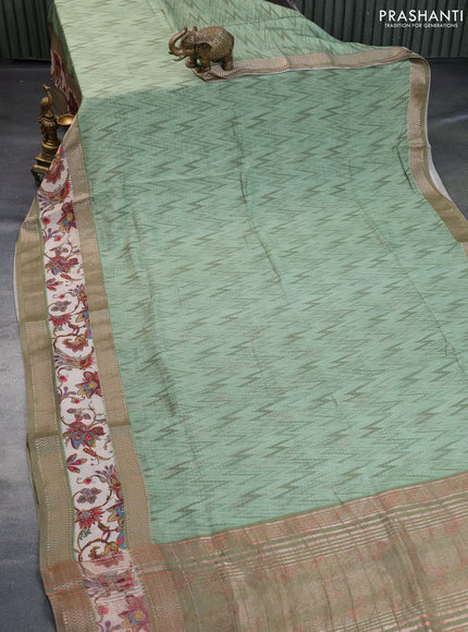 Muslin silk saree pastel green and beige with allover ikat weaves and rettapet zari woven printed border