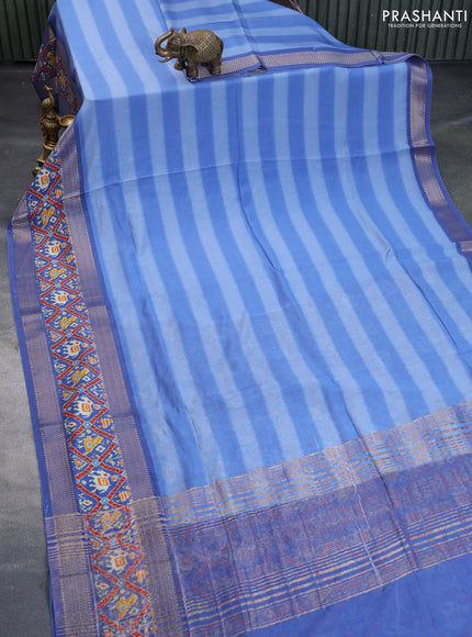 Muslin silk saree blue shade with allover stripes pattern and rettapet zari woven ikat style border