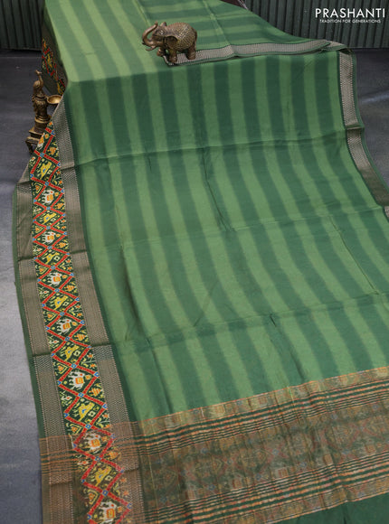 Muslin silk saree green with allover stripes pattern and rettapet zari woven ikat style border