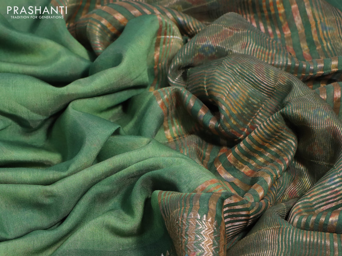 Muslin silk saree green with allover stripes pattern and rettapet zari woven ikat style border