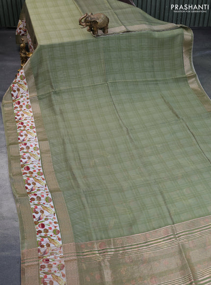 Muslin silk saree green shade and off white with checked pattern and rettapet zari woven printed border