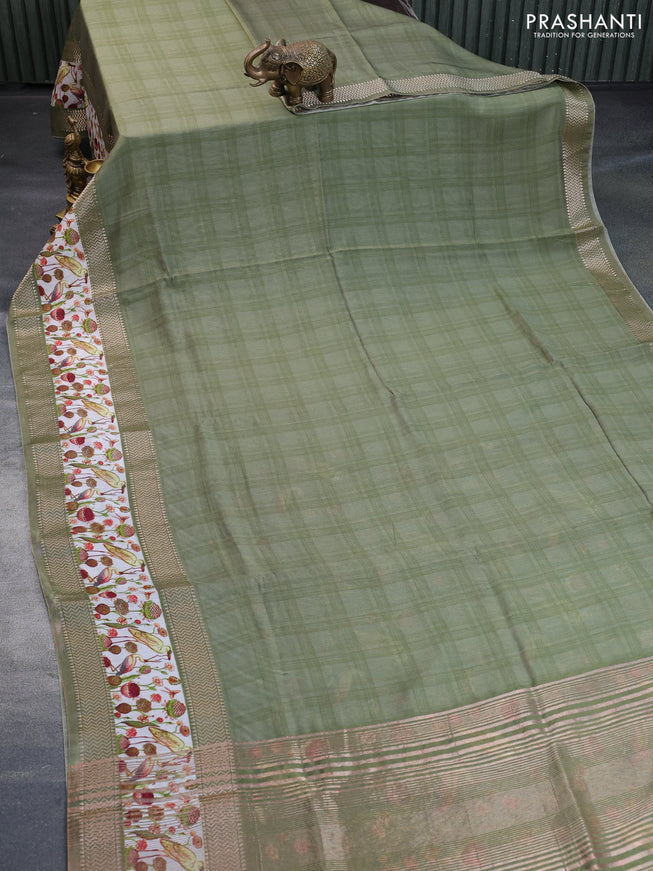 Muslin silk saree green shade and off white with checked pattern and rettapet zari woven printed border