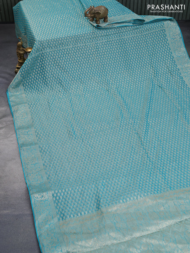 Crushed tissue saree teal blue with allover zari woven buttas and zari woven floral border