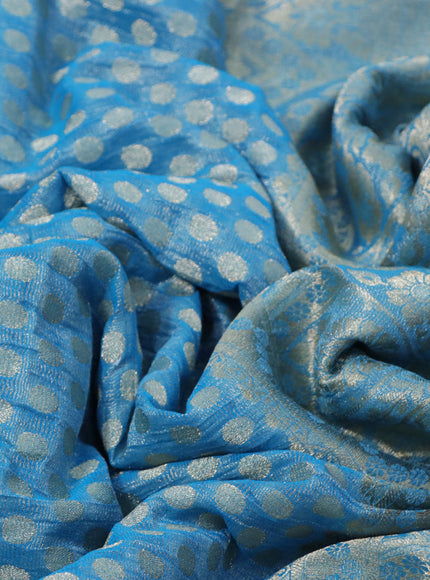 Crushed tissue saree cs blue with allover zari woven buttas and zari woven floral border