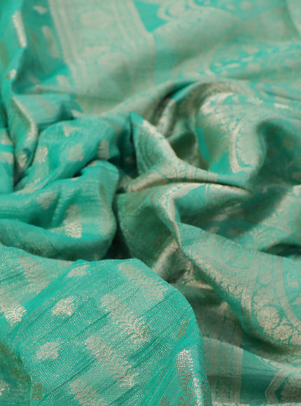 Crushed tissue saree teal green with allover zari woven buttas and zari woven floral border