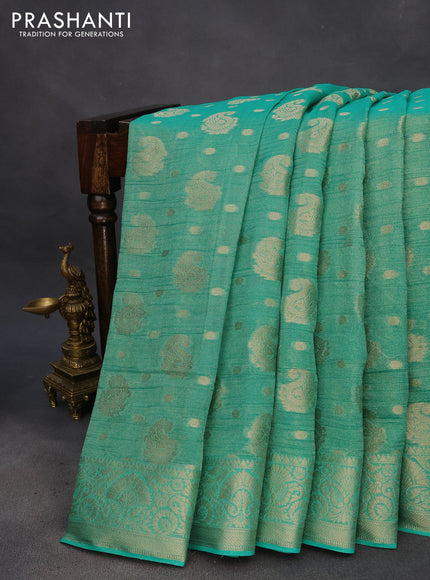 Crushed tissue saree teal green with allover zari woven buttas and zari woven border