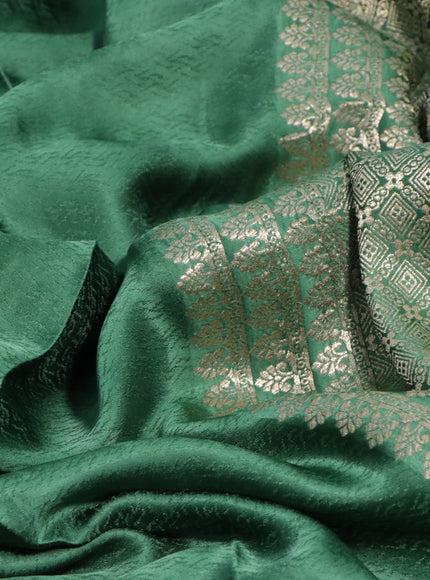 Mushru silk saree green with allover self emboss and elephant zari woven butta border