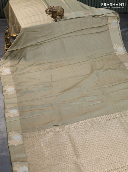 Mushru silk saree elaichi green with allover self emboss and elephant zari woven butta border