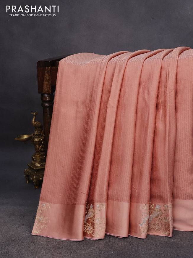 Mushru silk saree pastel peach with allover self emboss and zari woven butta border