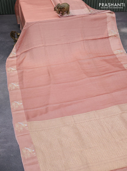 Mushru silk saree pastel peach with allover self emboss and zari woven butta border