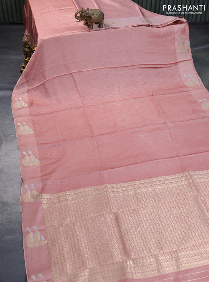 Mushru silk saree pastel peach with allover self emboss and zari woven butta border