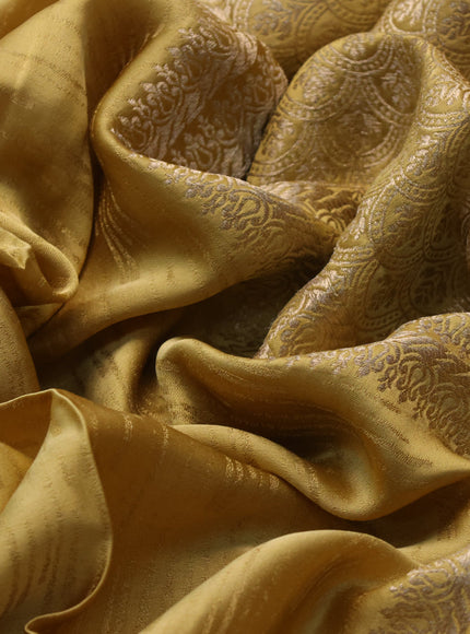 Mushru silk saree yellow with allover self emboss and zari woven butta border