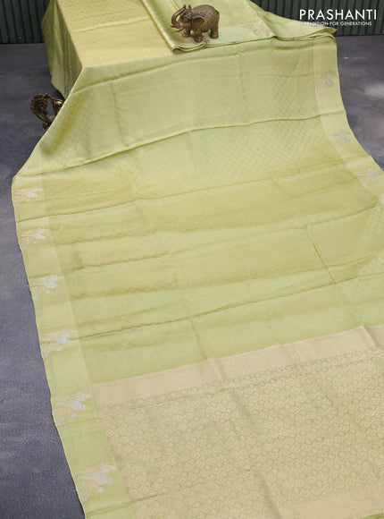 Mushru silk saree pista green with allover self emboss and zari woven butta border