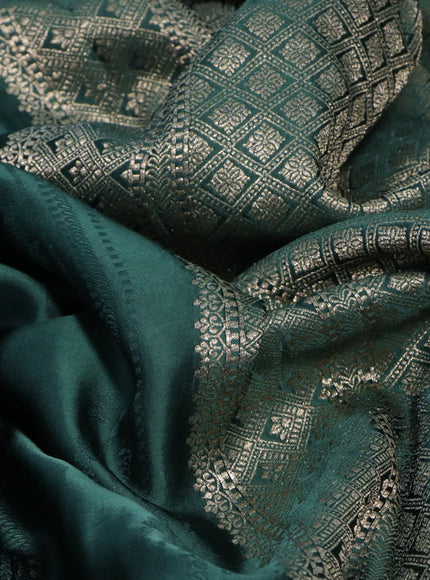 Mushru silk saree green with allover self emboss and zari woven butta border