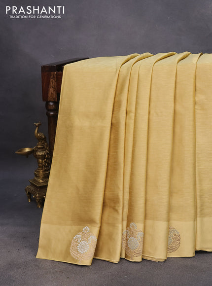 Mushru silk saree yellow shade with allover self emboss and zari woven butta border