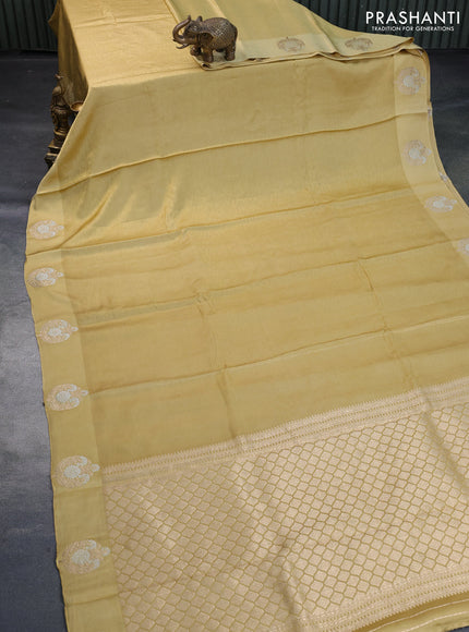 Mushru silk saree yellow shade with allover self emboss and zari woven butta border