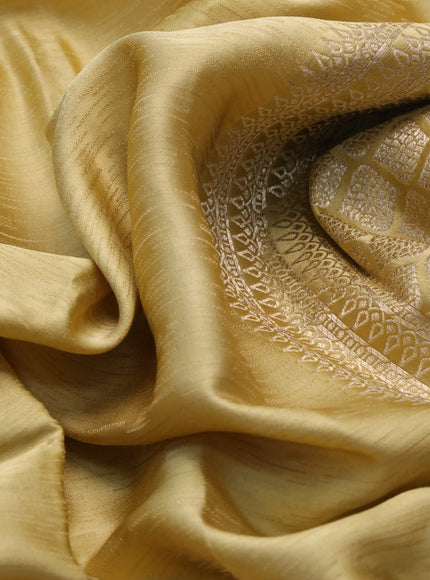 Mushru silk saree yellow shade with allover self emboss and zari woven butta border