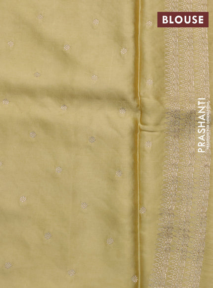 Mushru silk saree yellow shade with allover self emboss and zari woven butta border