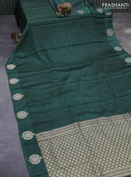 Mushru silk saree green with allover self emboss and zari woven butta border