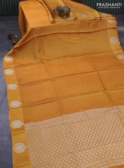 Mushru silk saree mustard yellow with allover self emboss and zari woven butta border