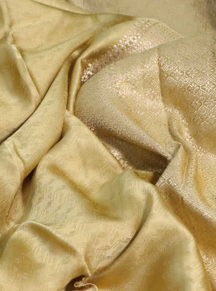 Mushru silk saree yellow shade with allover self emboss and zari woven butta border