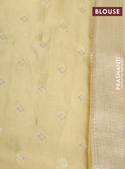 Mushru silk saree yellow shade with allover self emboss and zari woven butta border