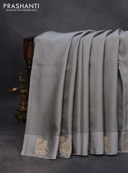 Mushru silk saree grey with allover self emboss and zari woven butta border