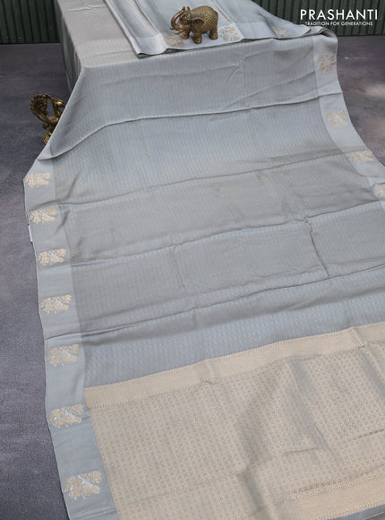 Mushru silk saree grey with allover self emboss and zari woven butta border