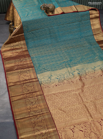 Kanchipuram silk saree teal green and maroon with allover zari woven brocade weaves and long zari woven border