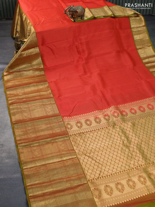 Kanchipuram silk saree orange and mehendi green with allover zari woven butta weaves and long annam zari woven border