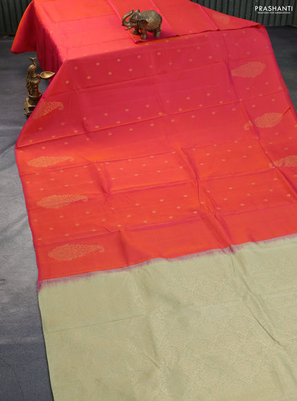 Kanchipuram silk saree dual shade of pinkish orange and elaichi green with zari woven buttas in borderless style