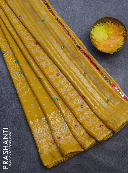 Semi georgette saree yellow with allover bandhani prints and mirror work printed border