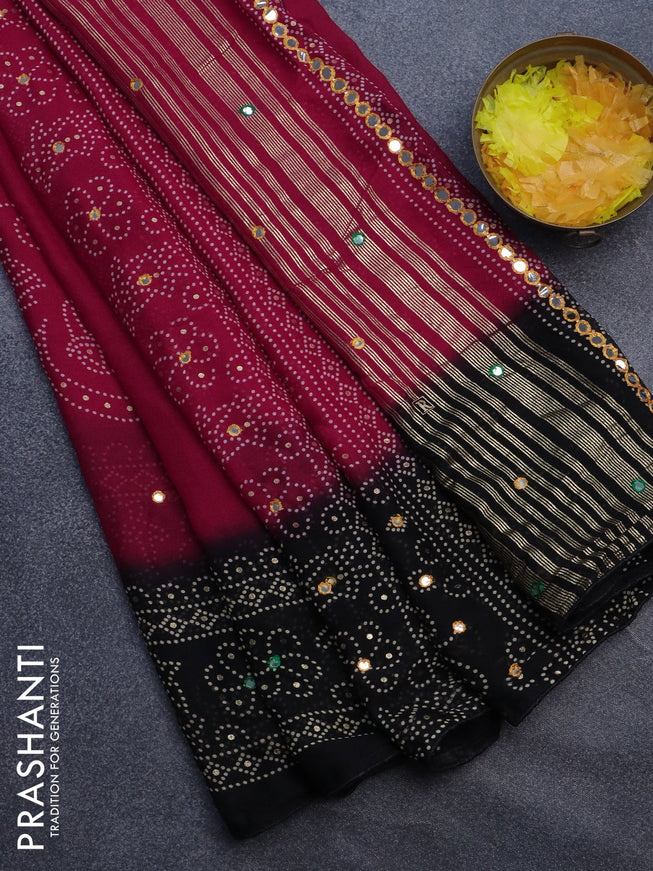 Semi georgette saree reddish pink and black with allover bandhani prints and mirror work printed border