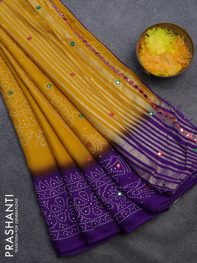 Semi georgette saree yellow and violet with allover bandhani prints and mirror work printed border