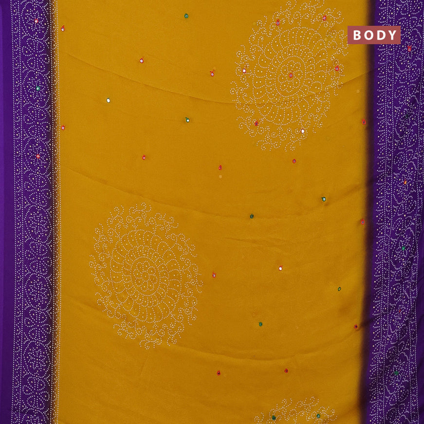 Semi georgette saree yellow and violet with allover bandhani prints and mirror work printed border