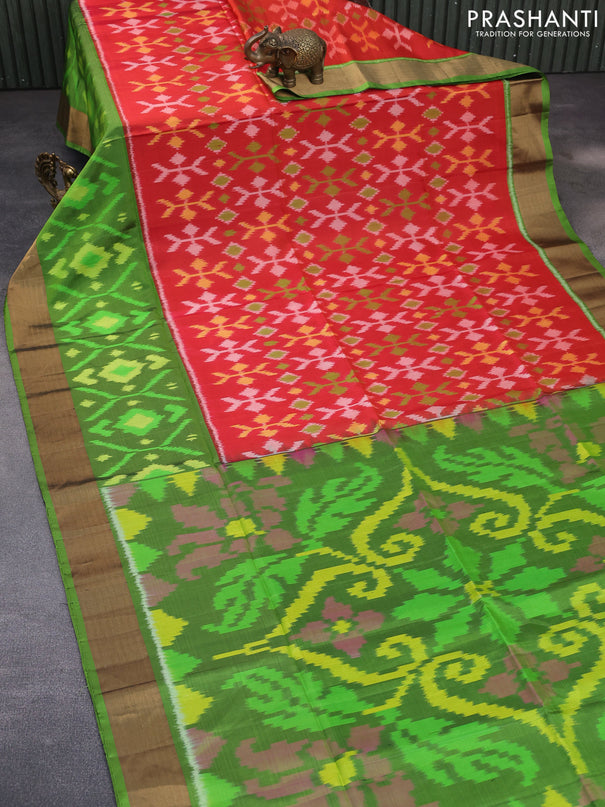 Ikat soft silk saree reddish orange and green with allover ikat weaves and long ikat woven zari border