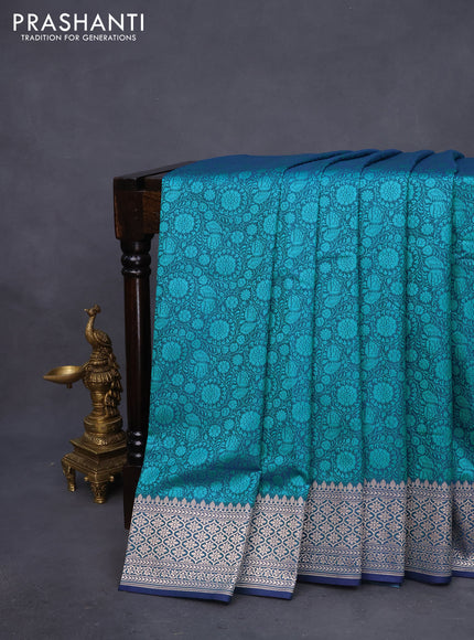 Mushru silk saree dual shade of bluish teal green with allover self emboss and rich zari woven border