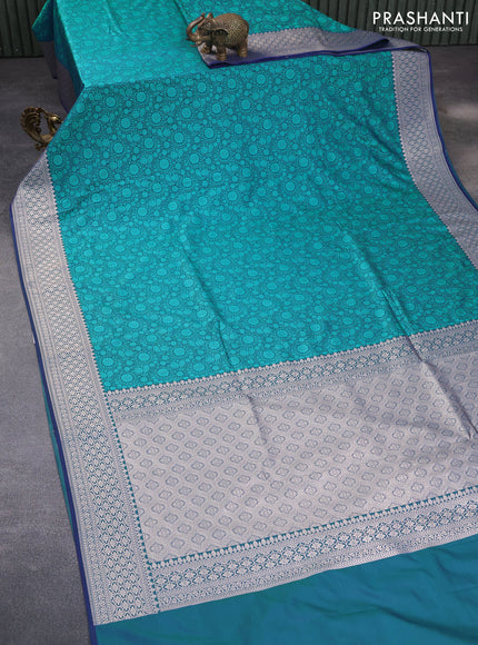 Mushru silk saree dual shade of bluish teal green with allover self emboss and rich zari woven border