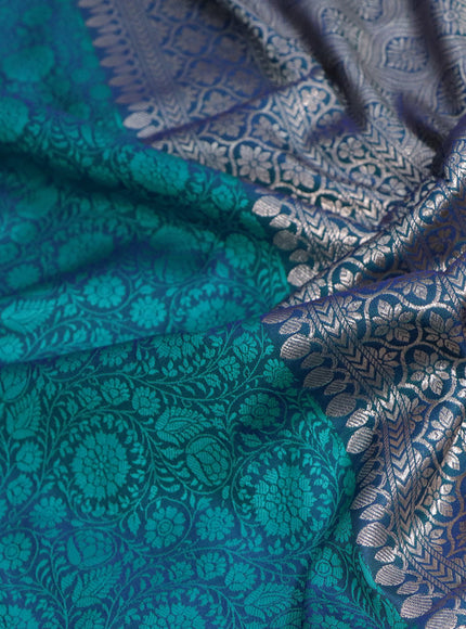 Mushru silk saree dual shade of bluish teal green with allover self emboss and rich zari woven border