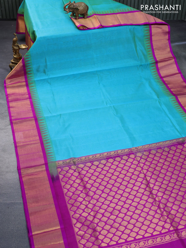 Kuppadam silk cotton saree dual shade of teal bluish green and purple with plain body and temple design zari woven border