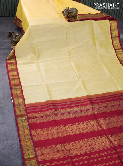 Silk cotton saree pale yellow and maroon with plain body and zari woven korvai border