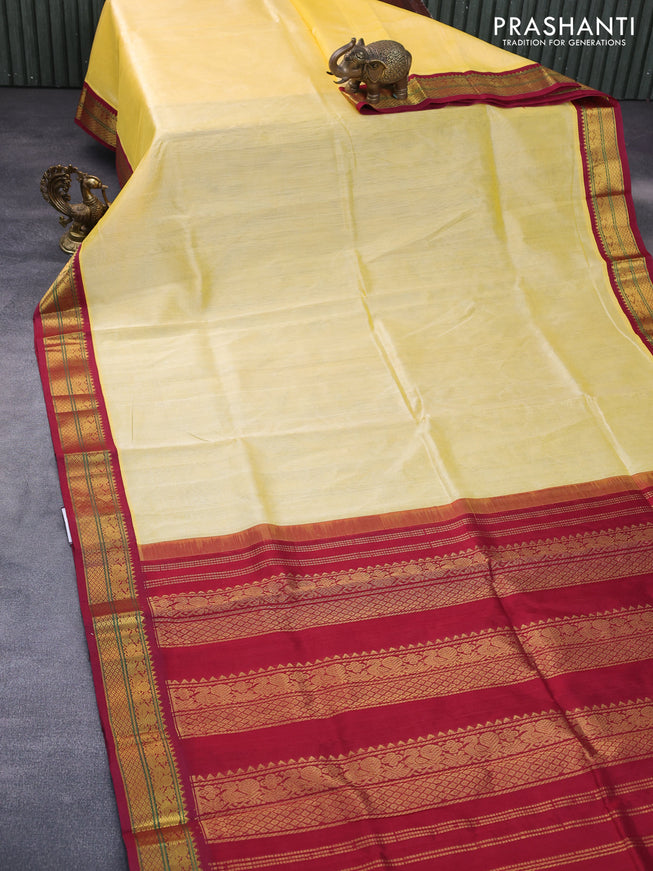 Silk cotton saree pale yellow and maroon with plain body and zari woven korvai border