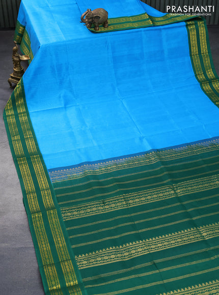 Silk cotton saree blue and green with plain body and rettapet zari woven korvai border