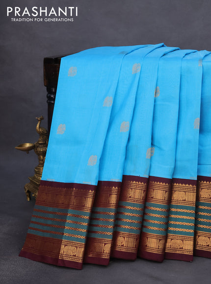 Silk cotton saree light blue and wine shade with elephant zari woven buttas and rich long zari woven korvai border