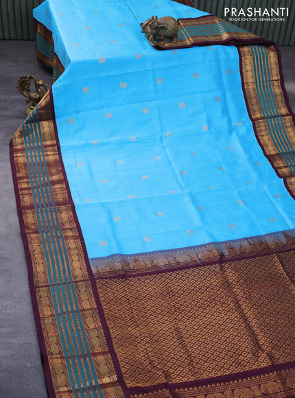 Silk cotton saree light blue and wine shade with elephant zari woven buttas and rich long zari woven korvai border