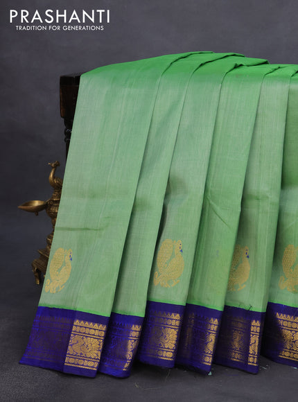 Silk cotton saree green and blue with plain body and annam zari woven korvai border