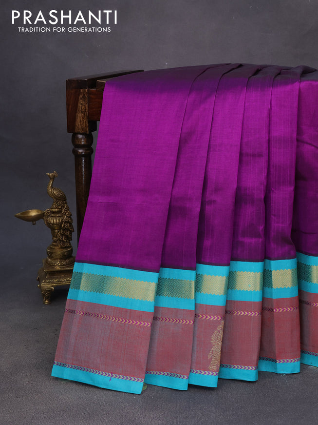 Silk cotton saree purple and teal blue with plain body and zari woven butta korvai border