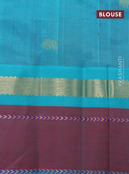 Silk cotton saree purple and teal blue with plain body and zari woven butta korvai border