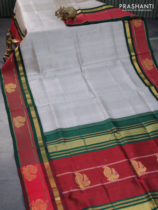 Silk cotton saree grey and green with plain body and zari woven annam butta korvai border